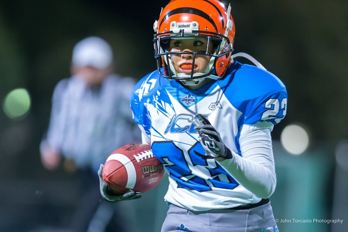The composition, technical quality, and colors in this photo are excellent. The football player may be inexperienced, but the photographer definitely isn’t. Author: John Torcasio