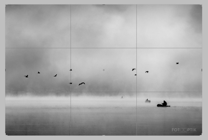A photo divided into thirds. One third contains water, the next contains the strip with flying birds, and the third contains fog. Photo: Imrich Gonda
