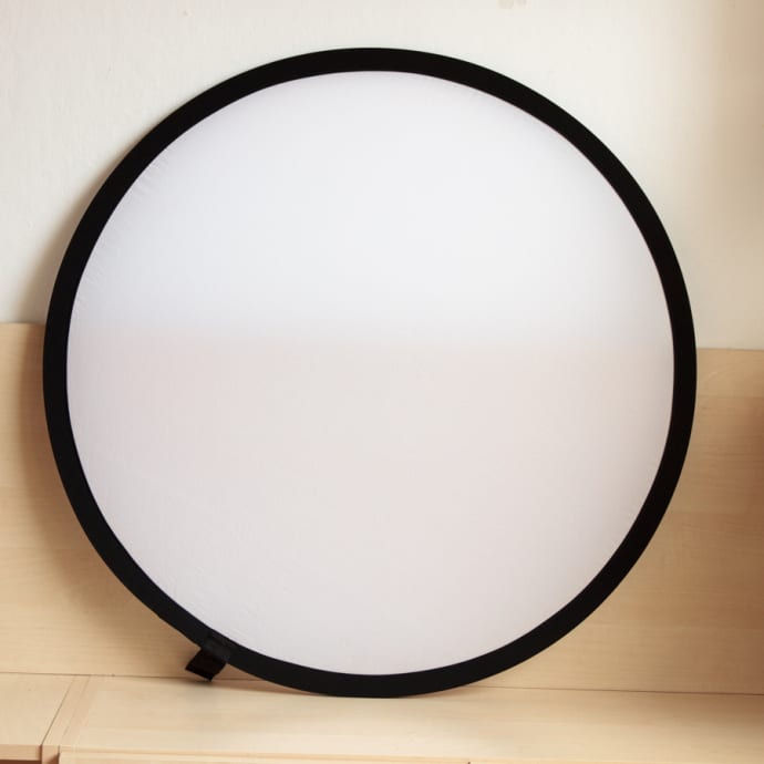 A diffusion sheet is used for softening (diffusing) hard light.