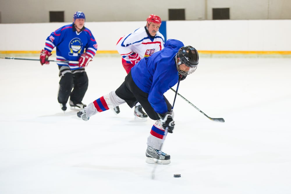 Not even 1/500 second was short enough to capture the hockey stick’s motion during the shot. Canon 5D Mark III, Canon EF 70-200/2.8 IS II, 1/500 s, f/2.8, ISO 3200, focal length 105 mm