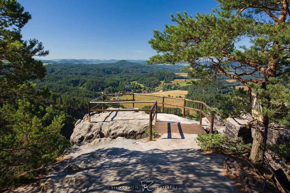 The 24 mm length from a greater distance, so the picture is framed by trees.