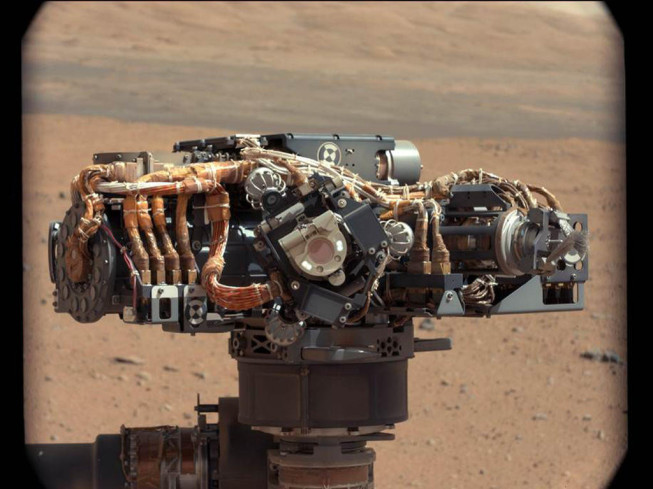 A photograph of one of the rover’s cameras, with Mars in the background. Photo: NASA/JPL-Caltech/MSSS.