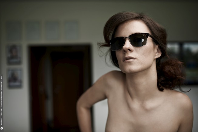 The glasses and the background are too visible here; this can’t really be called a “naked portrait.”