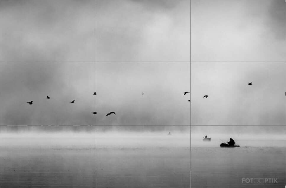 A photo divided into thirds. One third contains water, the next contains the strip with flying birds, and the third contains fog. Photo: Imrich Gonda