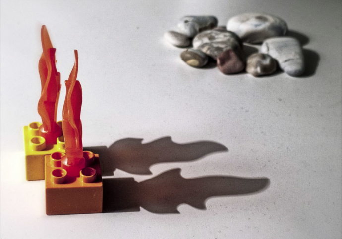 The main subject (the plastic flames and their shadows) is balanced out by the pile of rocks in the background. The rocks have been positioned diagonally from the flames and have been left out of focus. Panasonic Lumix DMC-LX 3, 1/15 s, f/2.8, ISO 200, focus 12.8 mm (60 mm equivalent) 