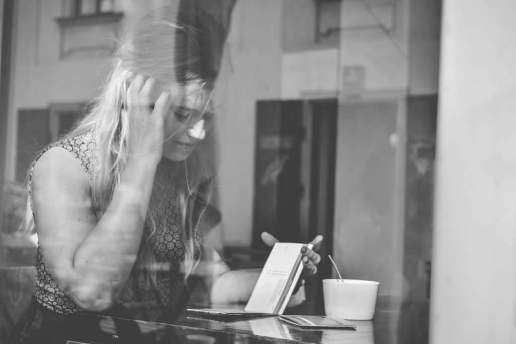 A girl sits inside a café, deciding what to order. I run out and capture the moment through the glass shop window. At my back is the sun, as well as the buildings that lie behind the model in the final photo. Nikon D3300, AF-S NIKKOR 18-55 mm 1:3.5-5.6 G II, 1/80 s, f/5 , ISO 100, focal length 46 mm