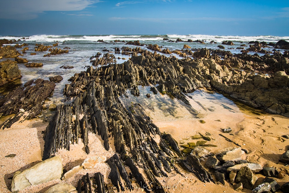 Nearby rocky outcroppings in the sand on the South African coast. Canon 40D, Sigma 18–50/2.8, 1/160 s, f/8.0, ISO 400, focal length 18 mm