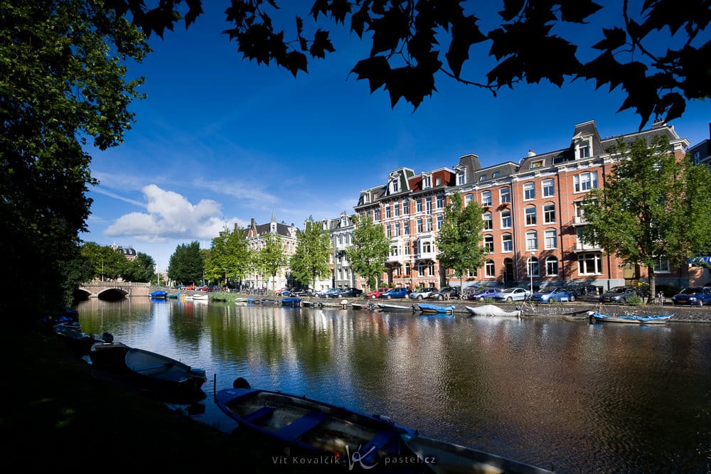 A canal in Amsterdam. Notice another rule of composition used here: framing (the leaves at the top). Canon 40D, Canon EF-S 10–22/3.5–4.5, 1/1600 s, f/8, ISO 200, focal length 10 mm