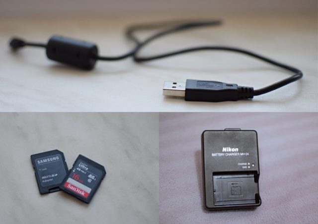 A USB cable, two memory cards, and a camera battery charger. These are the essentials that I take with me almost everywhere. Nikon D3300, AF-S NIKKOR 35 mm 1:1. 8 G