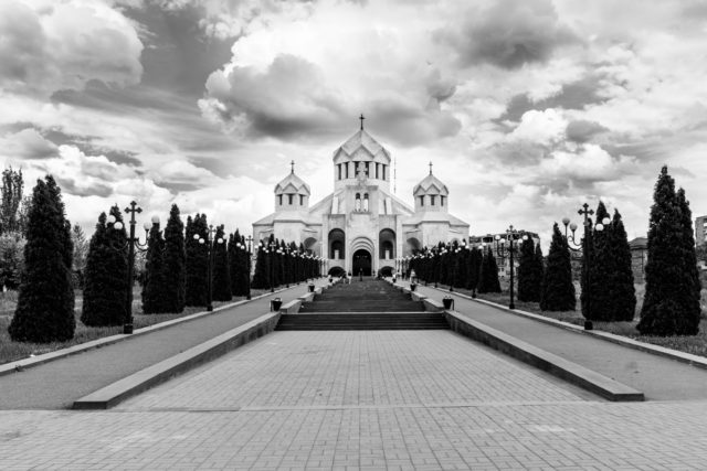 The alleys of trees along with the sidewalks on both sides form a guideline leading straight to the church.