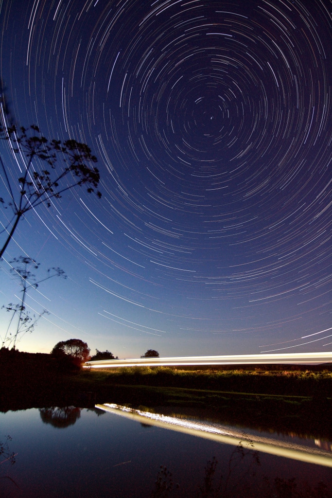 How to photograph star trails: stars and a passing train.