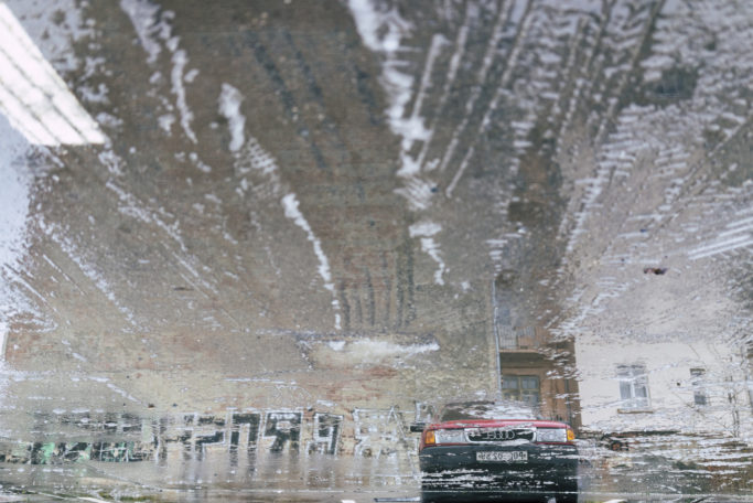 Discover the Wonders of Winter City Photography: reflection in a puddle.