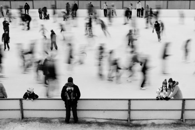 Discover the Wonders of Winter City Photography: a little bit blurred ice skaters.