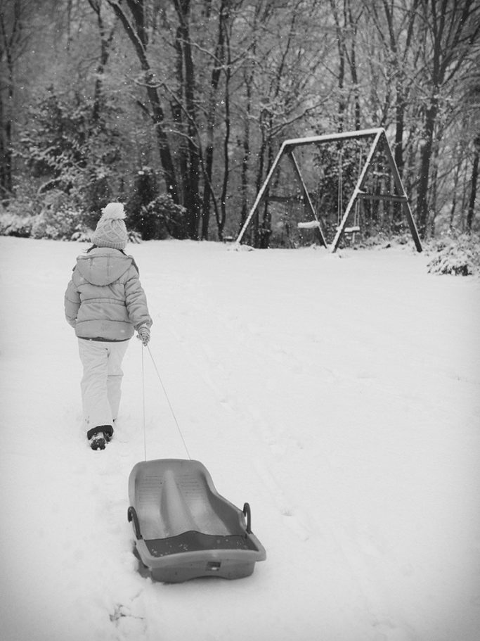 How to Photograph Children in Winter in Winter: A softly toned photo accentuates the falling snow.