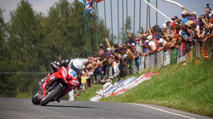 How to Photograph Motorcycle Races: a composition with fans in the background.