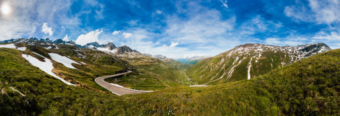 Photographing landscapes in rain and shine: a panorama with large clouds.