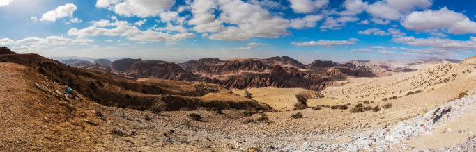 Photographing landscapes in rain and shine: a panorama with light clouds.