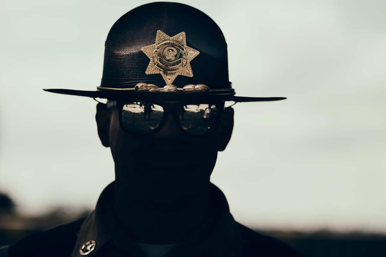 car photo, galerie, American style policeman. Exposed to the lights. Badge and glasses glare were accentuated in post-production using ZPS X.